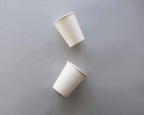 Two white paper cups with no lids