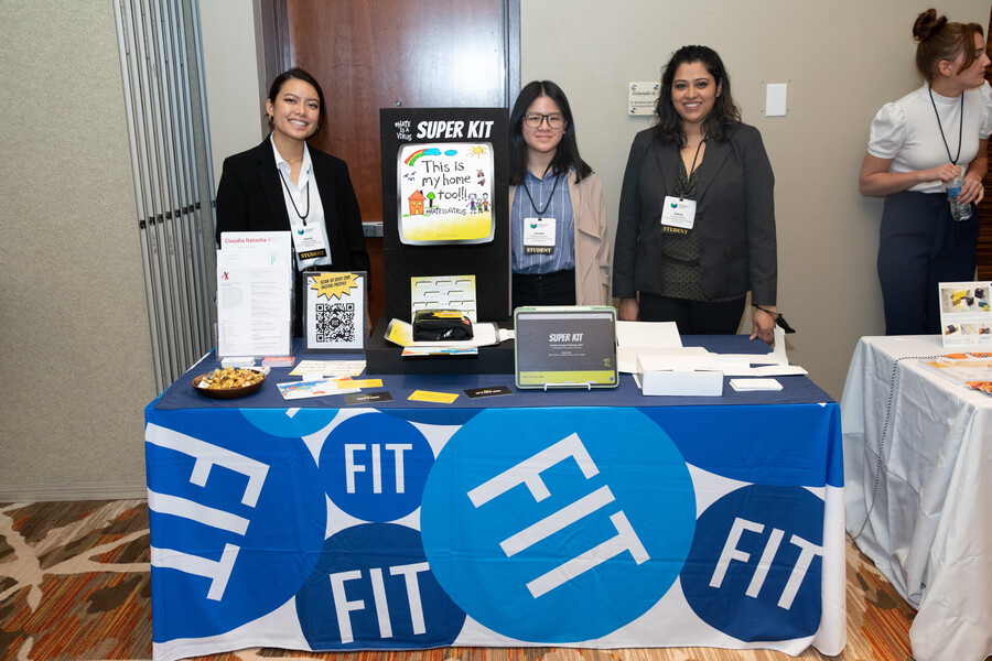 The FIT Team stands at their booth showcasing their Hate is a Virus prototype.